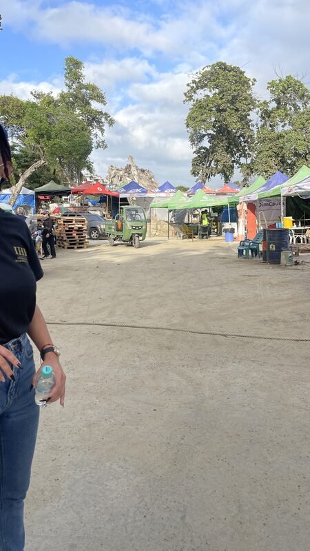 Cori, in a branded Humanitarian Response Team shirt, photographs the earthquake damage.