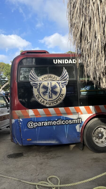A branded ambulance/response vehicle parked at the roadside.